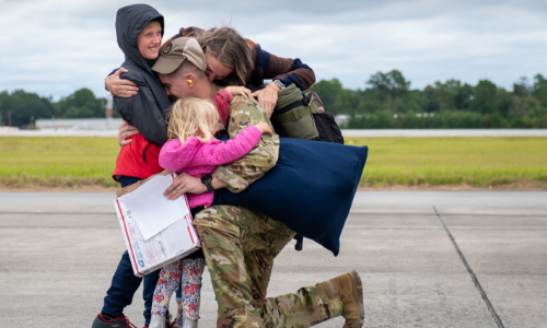Soldier embracing family