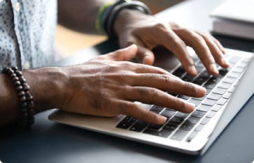 hands typing on laptop